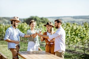 Friends tasting wine on the vineyard